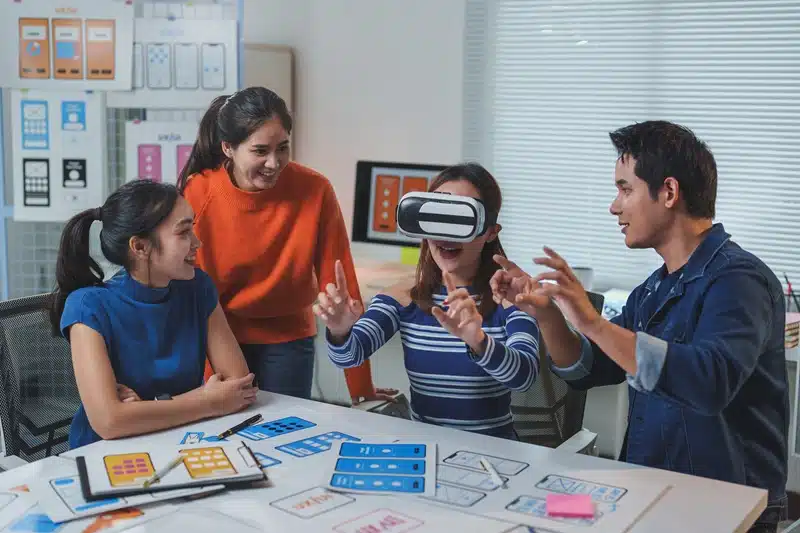 Game development team exploring a new gameplay mechanic using virtual reality during early planning and design discussions.